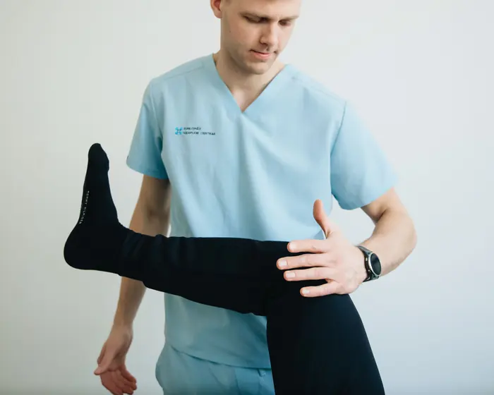 Physiotherapist assessing a patient's knee and hip movement