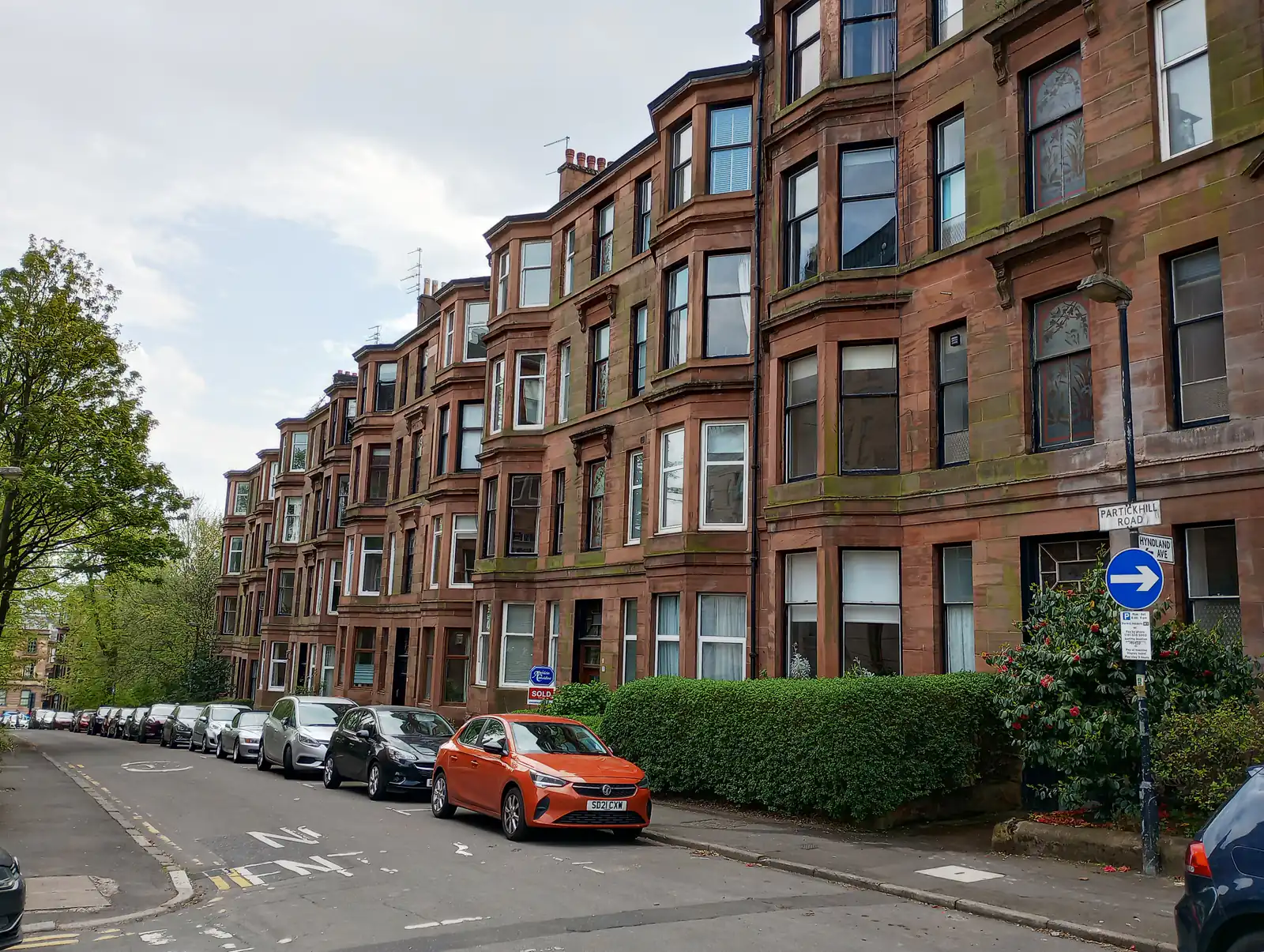 Red sandstone tenements with bay windows lining Partickhill Road beside Hyndland, Glasgow West End